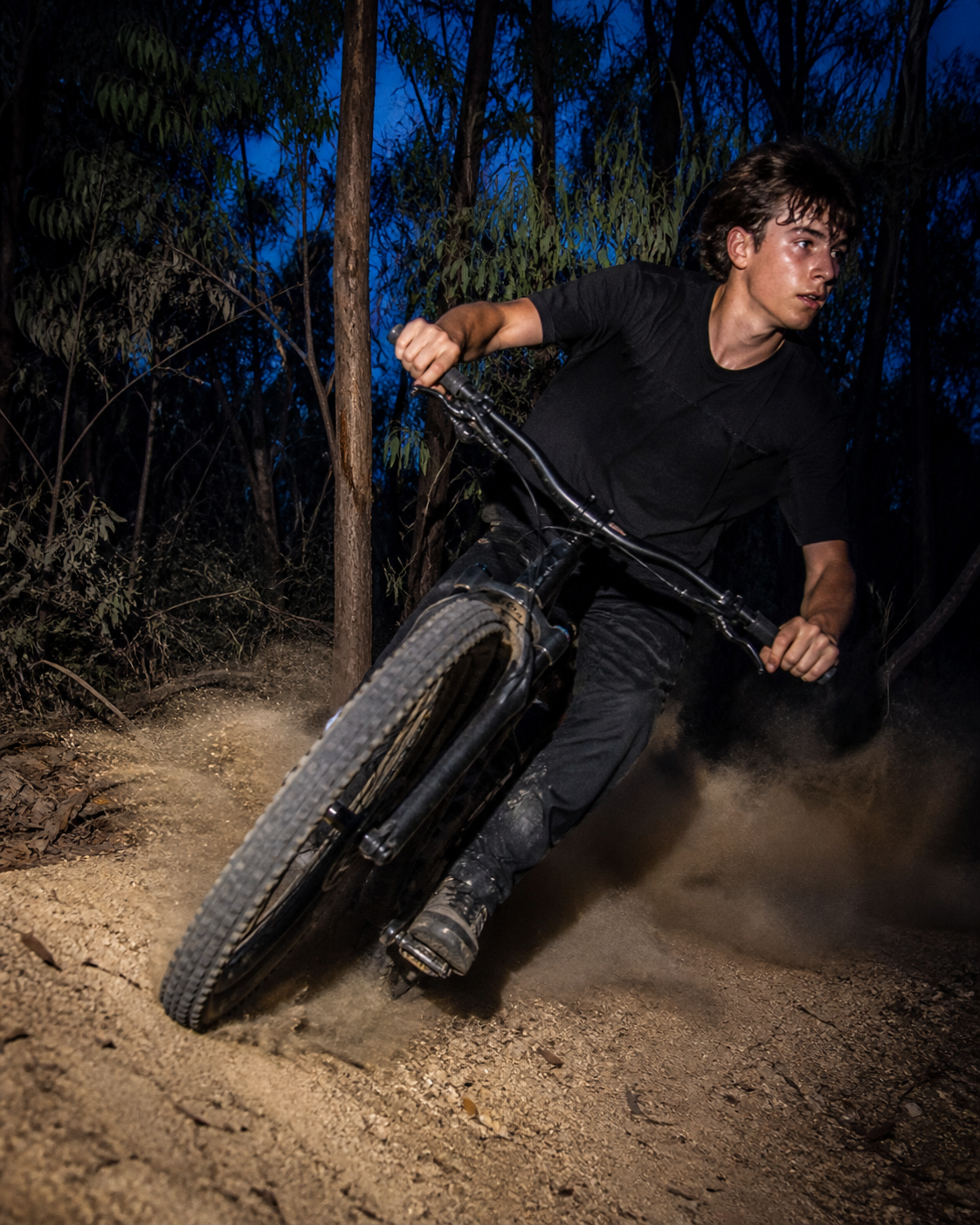 A rider carving through dust on a mountain bike